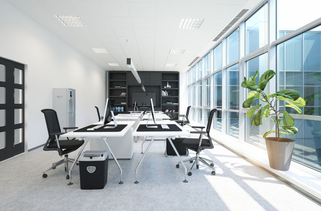 Professional cleaning technician using HEPA vacuum and sanitizing high-touch surfaces in modern Apex, NC workspace