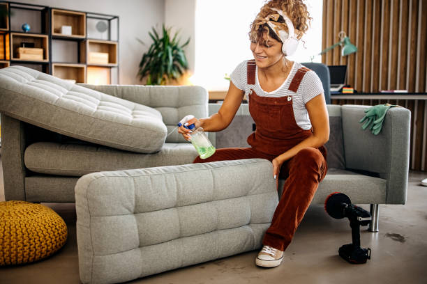 Cleaner doing deep washing of sofa with professional equipment Bright Leaf Cleaning team performing deep cleaning in Wake Forest NC