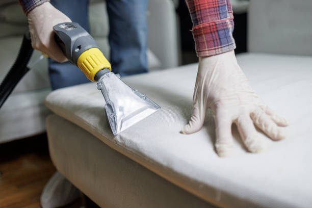 Dry cleaning of furniture. Specialist vacuum-cleaning the couch. Deep cleaning team working inside Sanford NC residential property