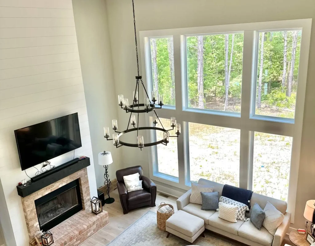 Residential cleaning technician vacuuming living room carpet in Chapel Hill