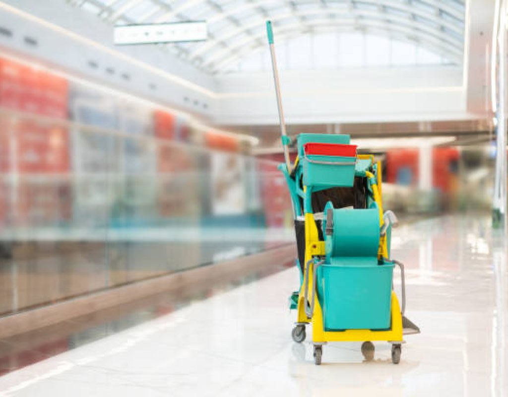 Cleaning staff preparing retail floors and front entrance before morning opening